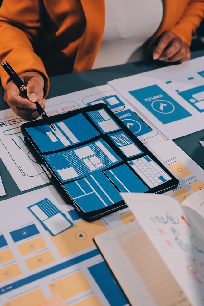 The designer team is designing the uxui system to make the uxui system work well on new phones and support system updates. Website development concept UI UX front end designer photo