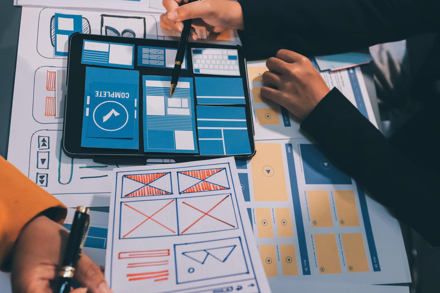 The designer team is designing the uxui system to make the uxui system work well on new phones and support system updates. Website development concept UI UX front end designer photo