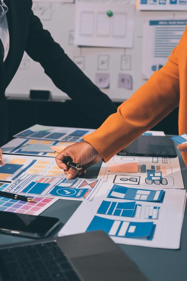 The designer team is designing the uxui system to make the uxui system work well on new phones and support system updates. Website development concept UI UX front end designer photo