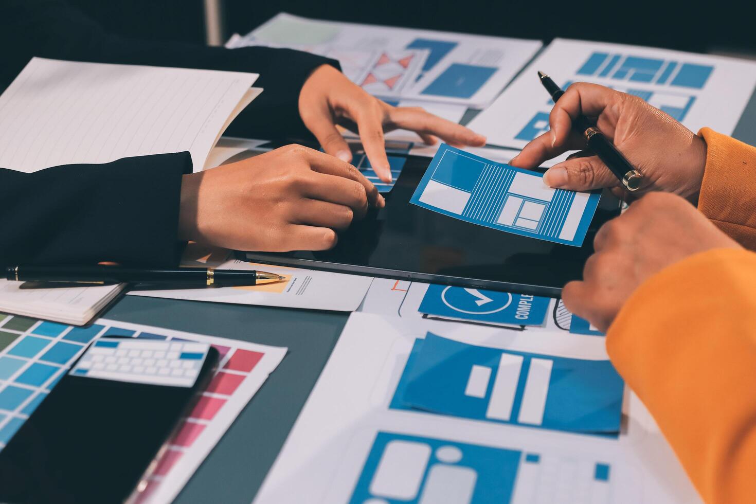 The designer team is designing the uxui system to make the uxui system work well on new phones and support system updates. Website development concept UI UX front end designer photo