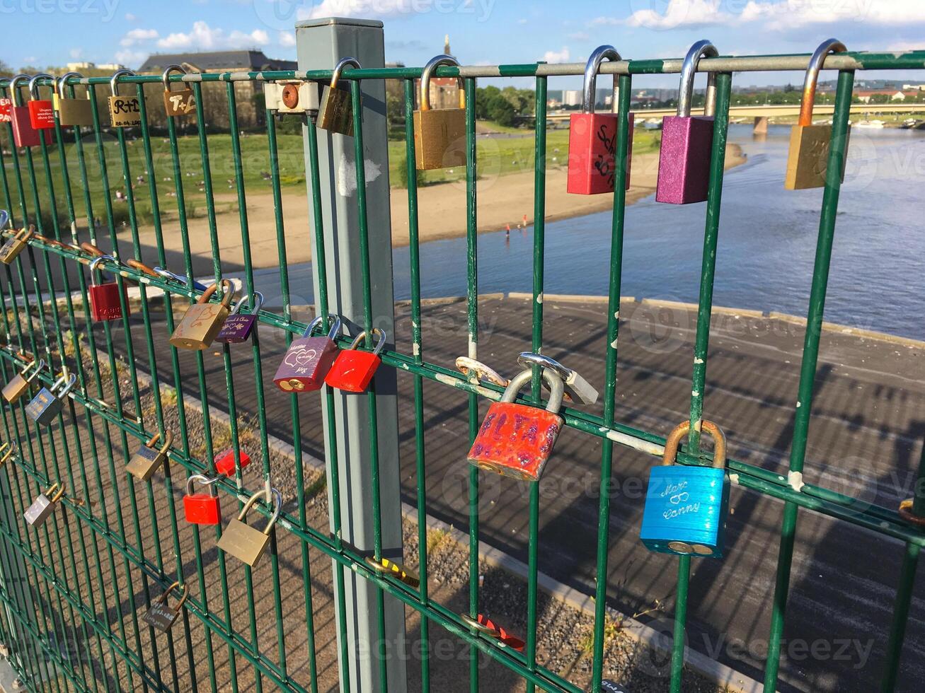 Love locks on the bridge. Close up of lock and key hole. Valentine's day. Metal padlock heart of lovers. Wedding tradition photo