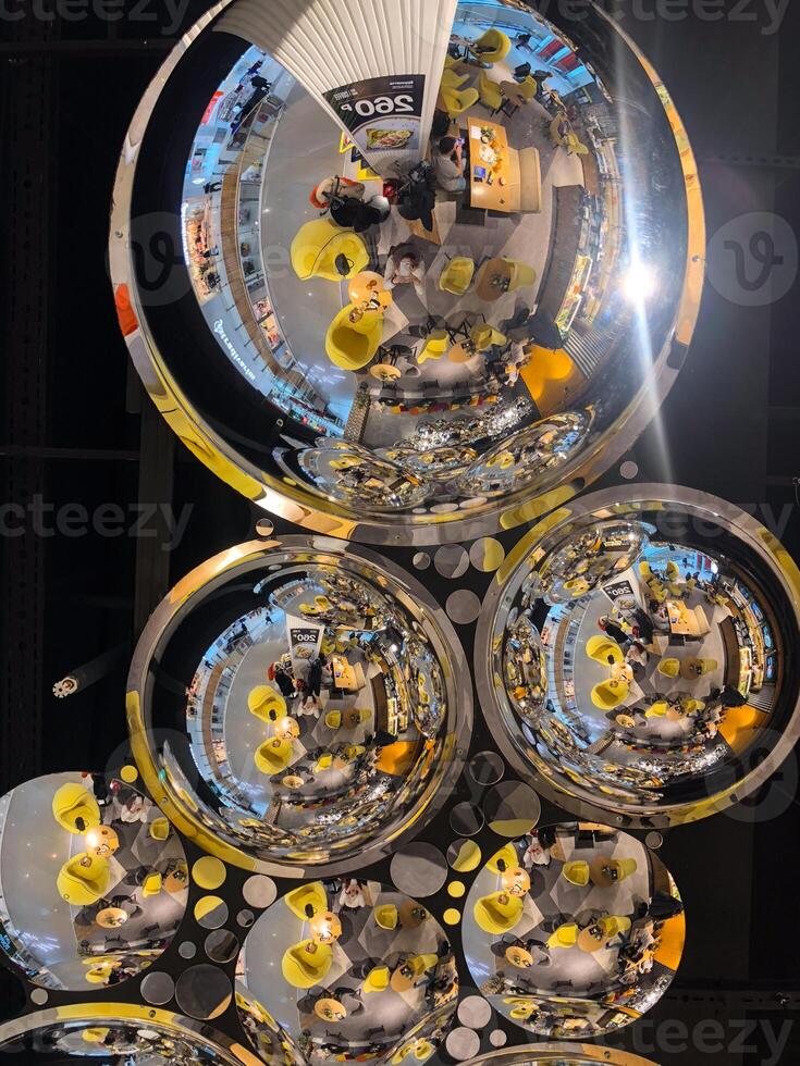 Shimmering Reflections from Spherical Mirrors on a Modern Ceiling. Geometry and Light Creates a Captivating Artistic Display in a Public Space. photo