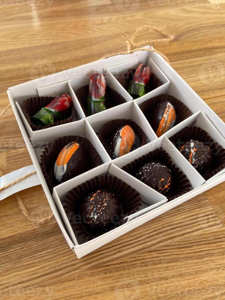 Box of artisanal chocolates vibrant, artistic designs for chocolate enthusiasts. Luxury of gourmet confections. Artistic expression in food and gourmet experience concept photo