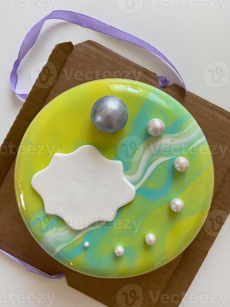 Mousse cake with white chocolate and meringue. Homemade vegan healthy dessert. Cake with green icing. Birthday present. Delicious gift photo