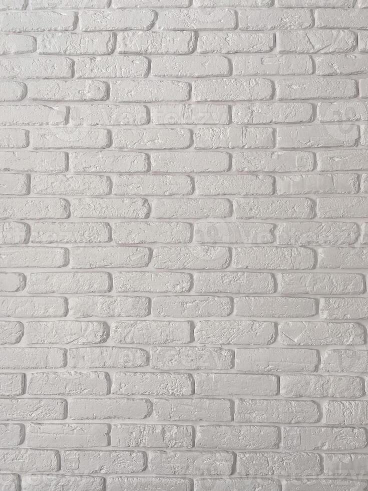 Detailed view of a white brick wall, showcasing its textured surface and uniform pattern. Simplicity and elegance of minimalistic interior design. Background with copy space and empty place for text photo