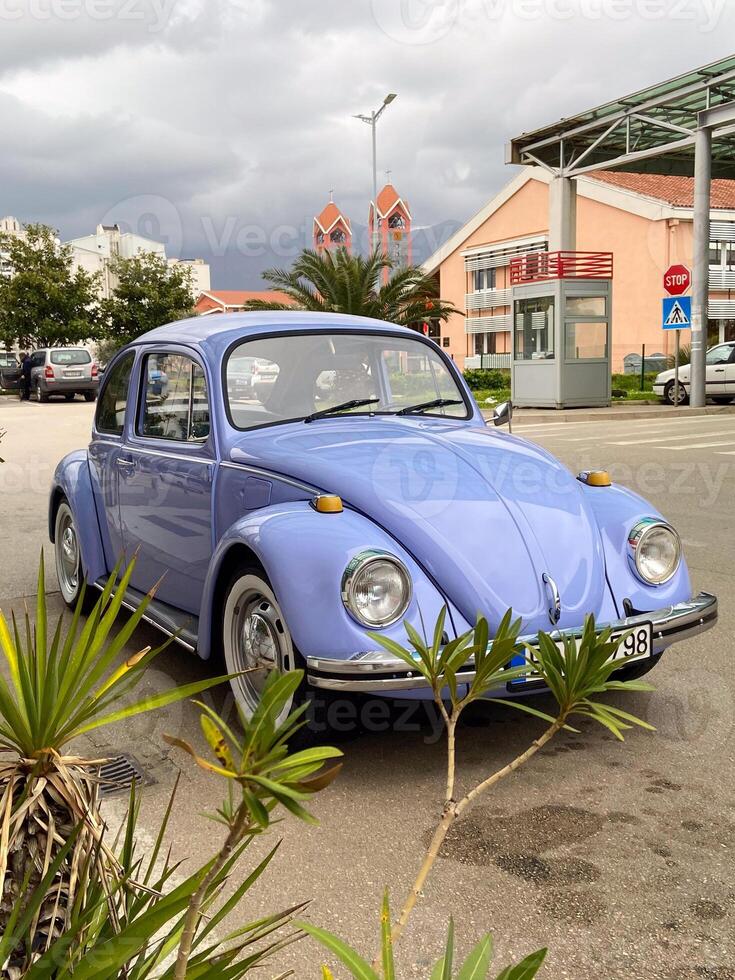 Vintage violet car on the street in summer. Old-fashioned nostalgia and retro style concept photo