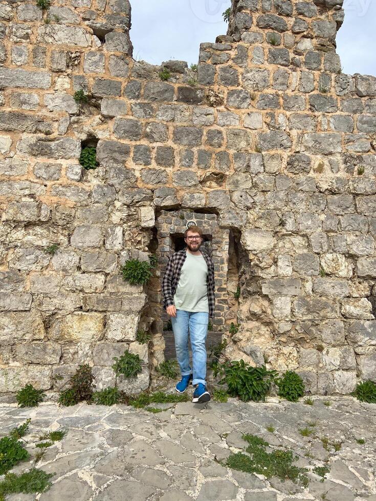 Man walking on ruins of fortress in Stary Grad , Bar, Montenegro photo