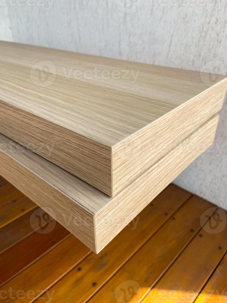 Stacked wooden planks display an exquisite blend of natural texture and modern design. Warm tones and linear grain pattern bring elegance and simplicity to this architectural detail photo