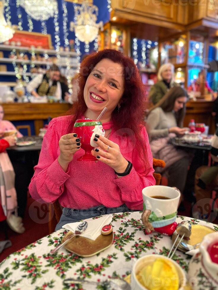 Happy Woman Eating Cake at Christmas Dinner Party - Smiling girl eating dessert at Xmas festivity photo