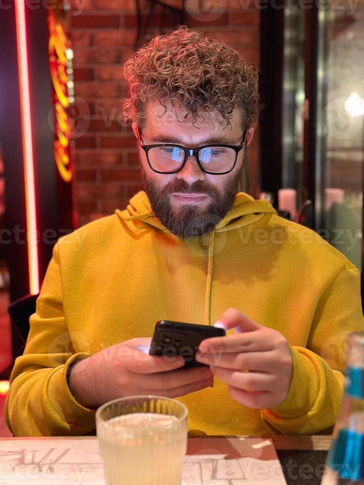 Casually man checking messages at a restaurant. taking a comfortable moment to stay connected. photo