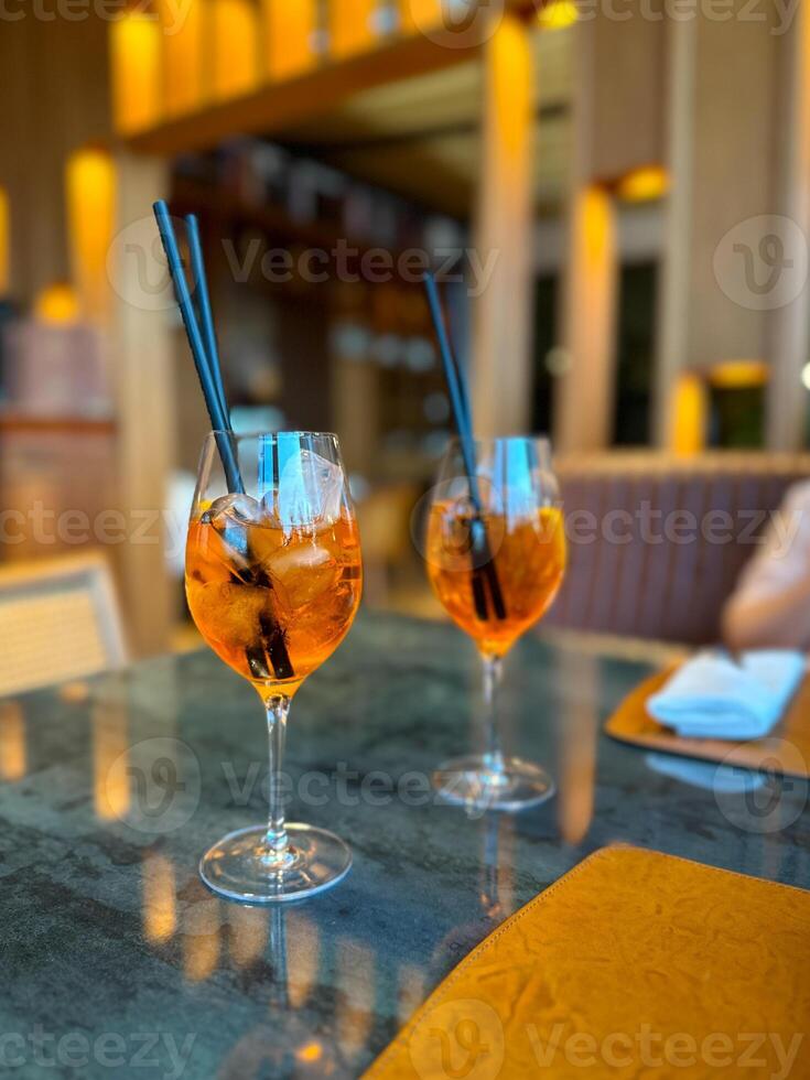 Aperol Spritz - A refreshing Italian cocktail combining Aperol, Prosecco, and a splash of soda, garnished with an orange slice, perfect for warm days and casual gatherings photo