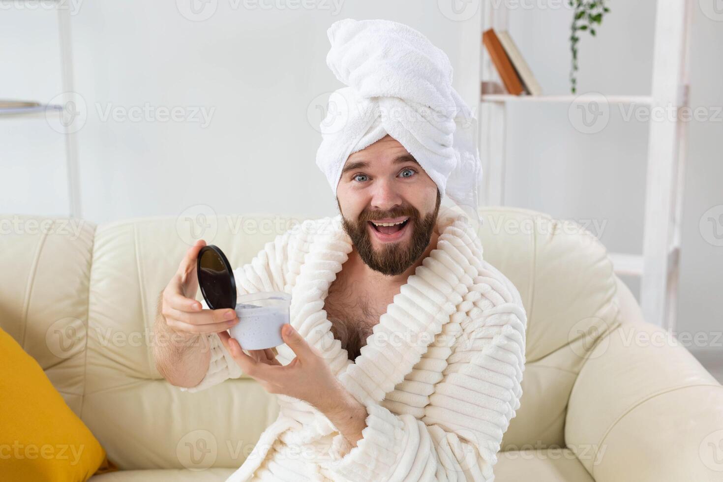 Portrait of man applying effective cream on his facial skin. Spa at home, body and skin care for male concept. photo