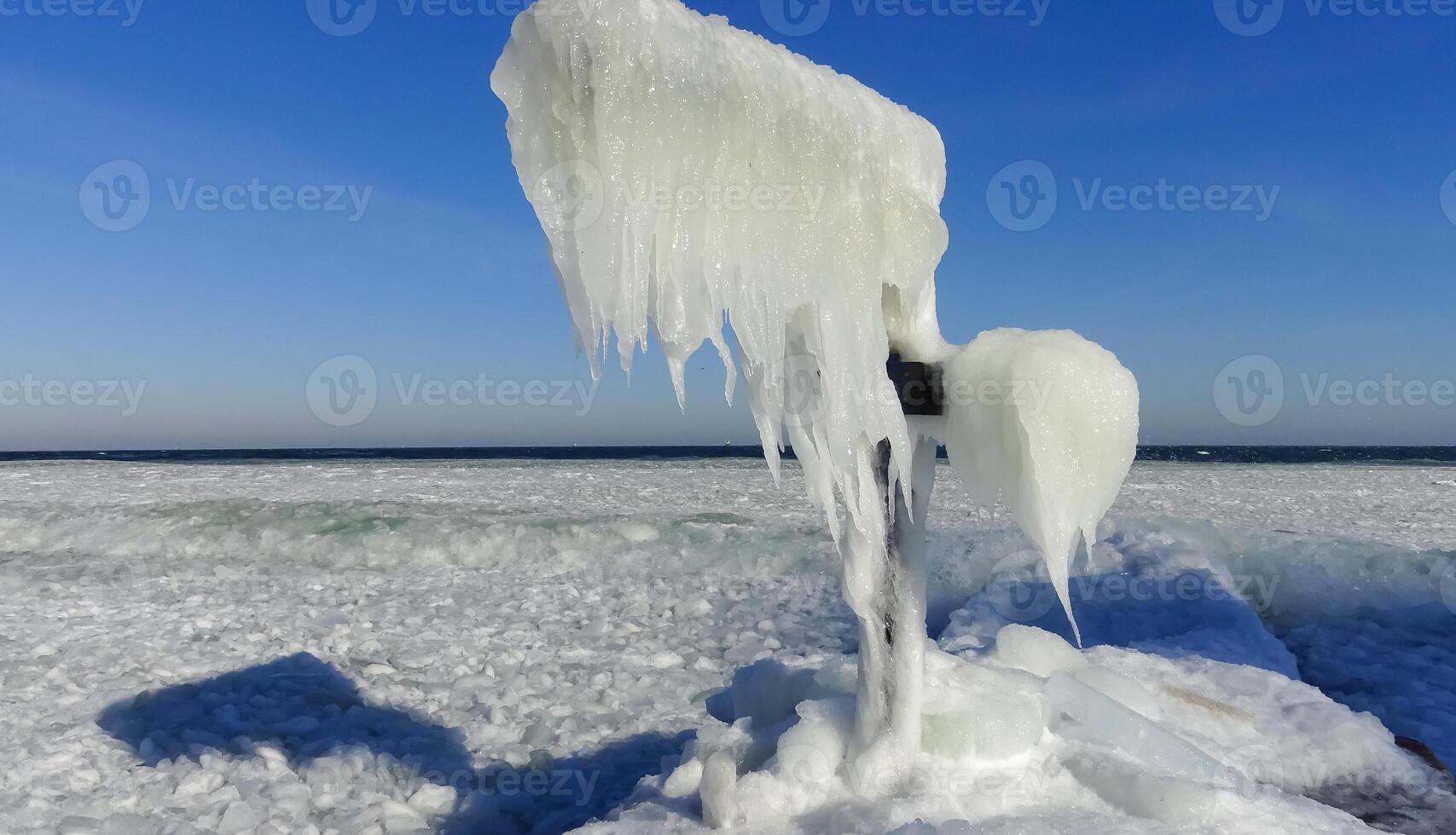 Frozen Black Sea, blocks of ice on the shore on the pier photo