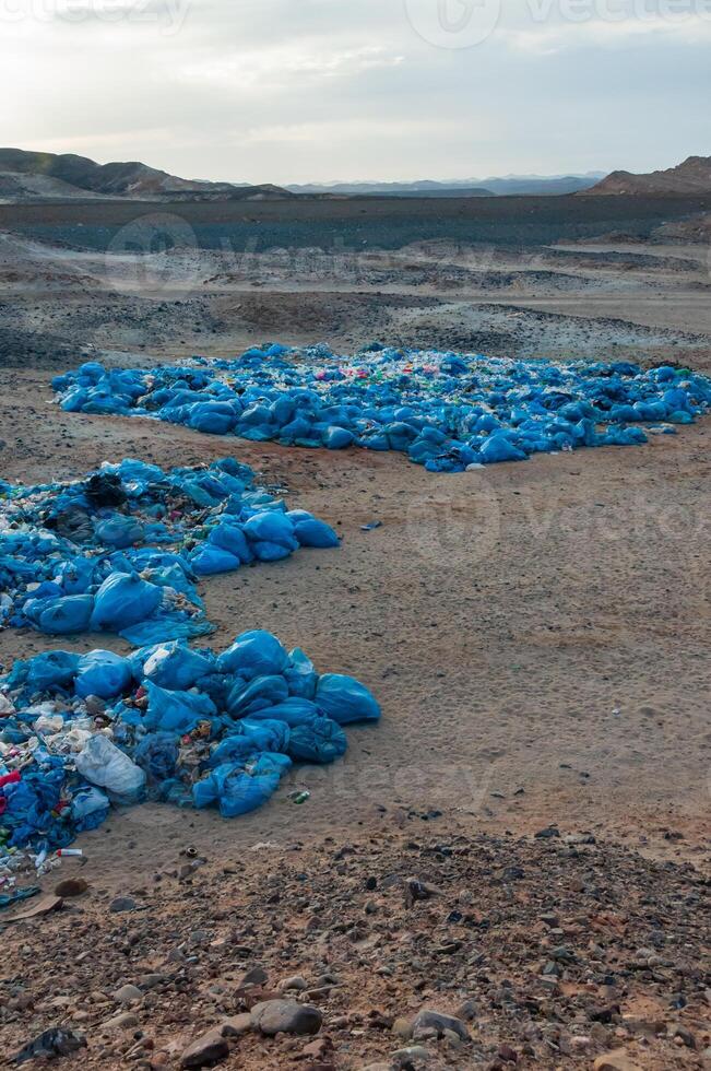 Plastic bottles and various garbage from hotels in the wild, Garbage dump in the desert in Egypt photo