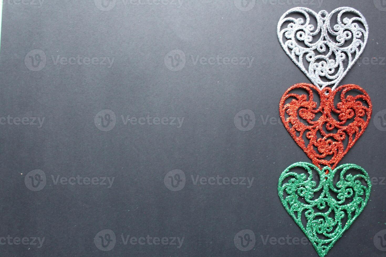 Three colored silver red fishnet colours on a black background with a copyspace spot for the Valentine's Day text photo