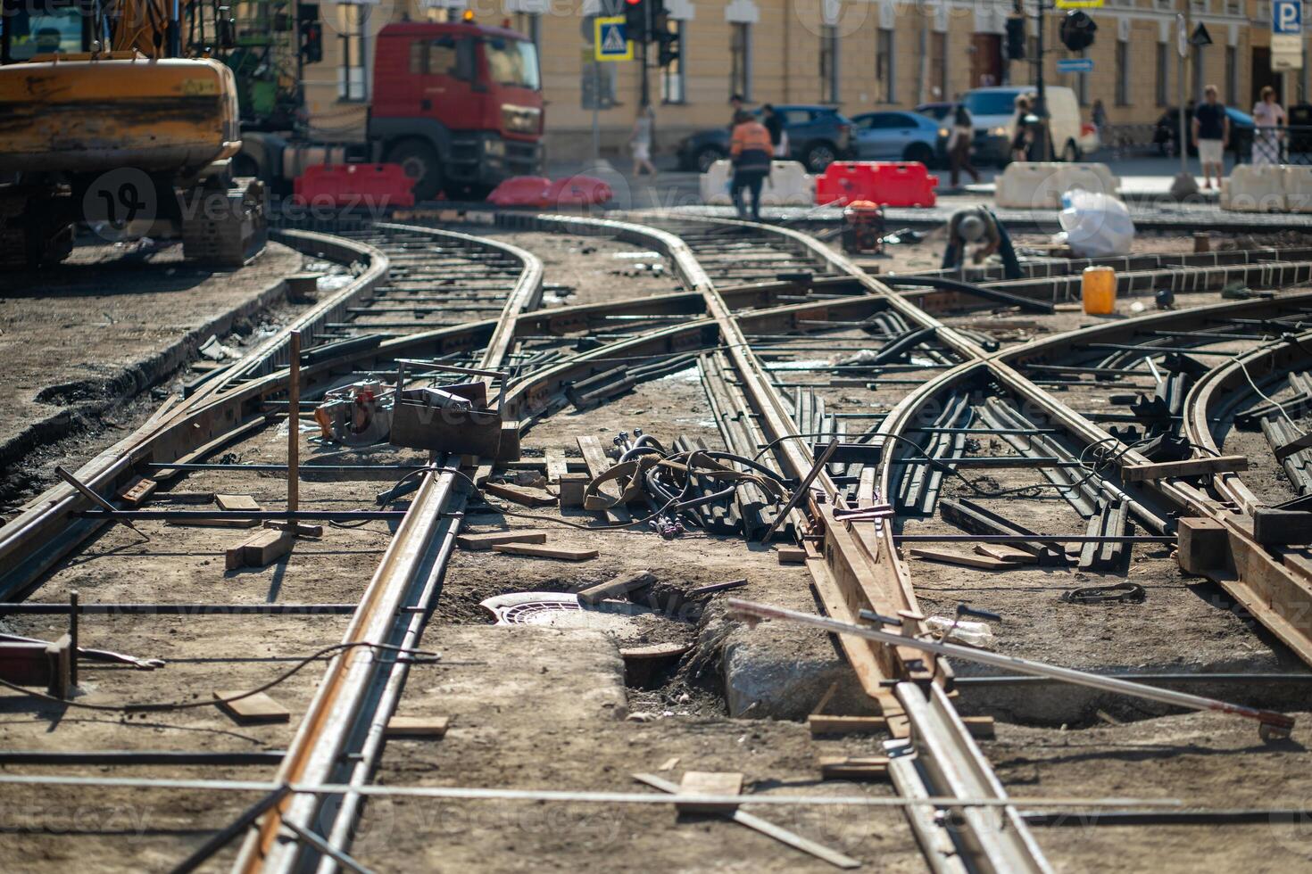 Construction site with scattered beams and rails, major tram track and asphalt replacement photo