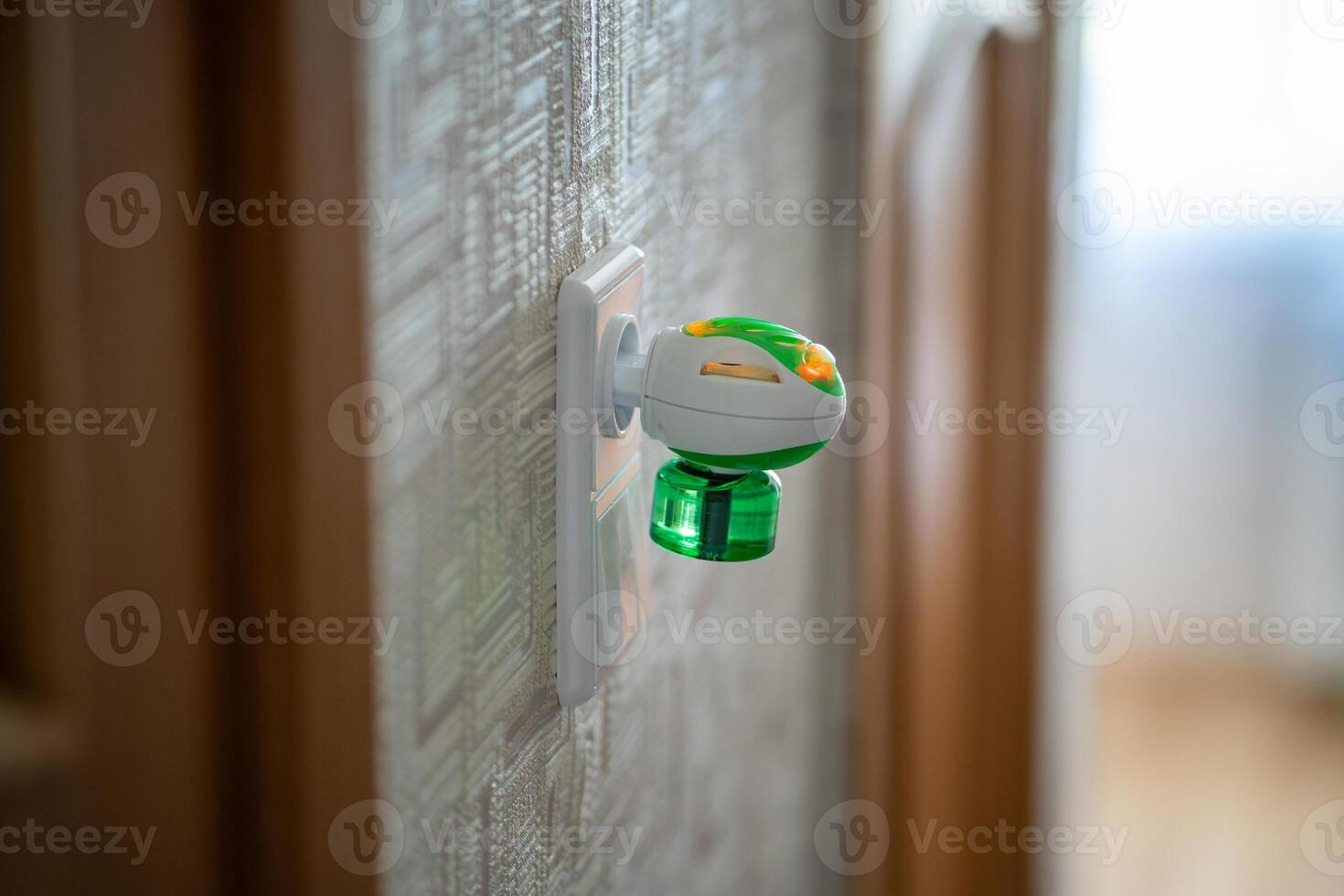 Mosquito repellent with plug into the socket at home. Electric insect repellent diffuser closeup photo