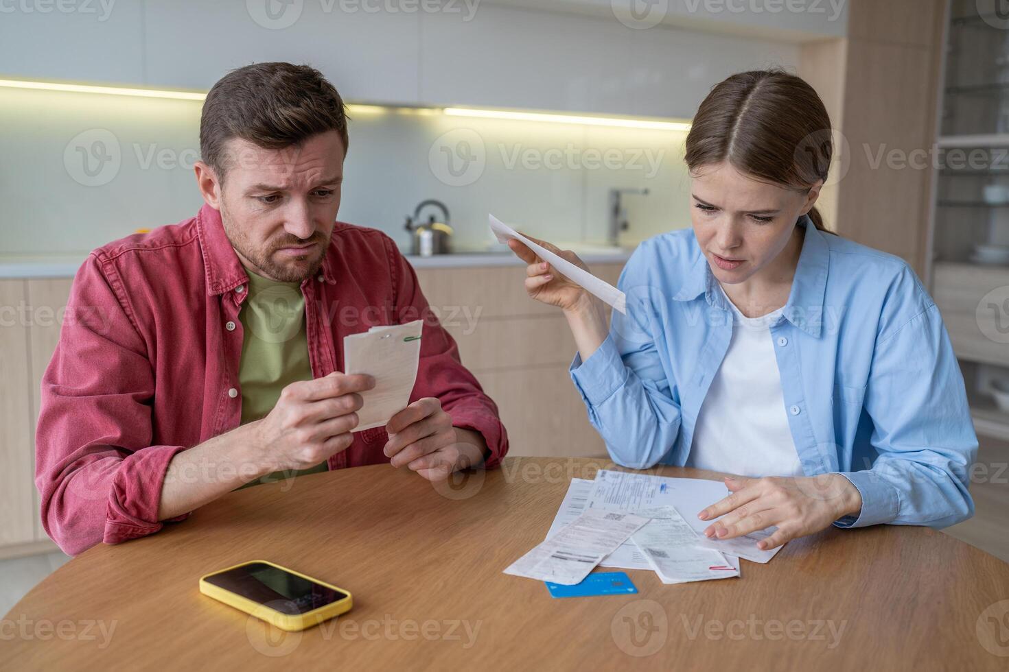 Distressed couple of man, woman sort bills, rent, utilities, dealing with debts and overdue payment photo