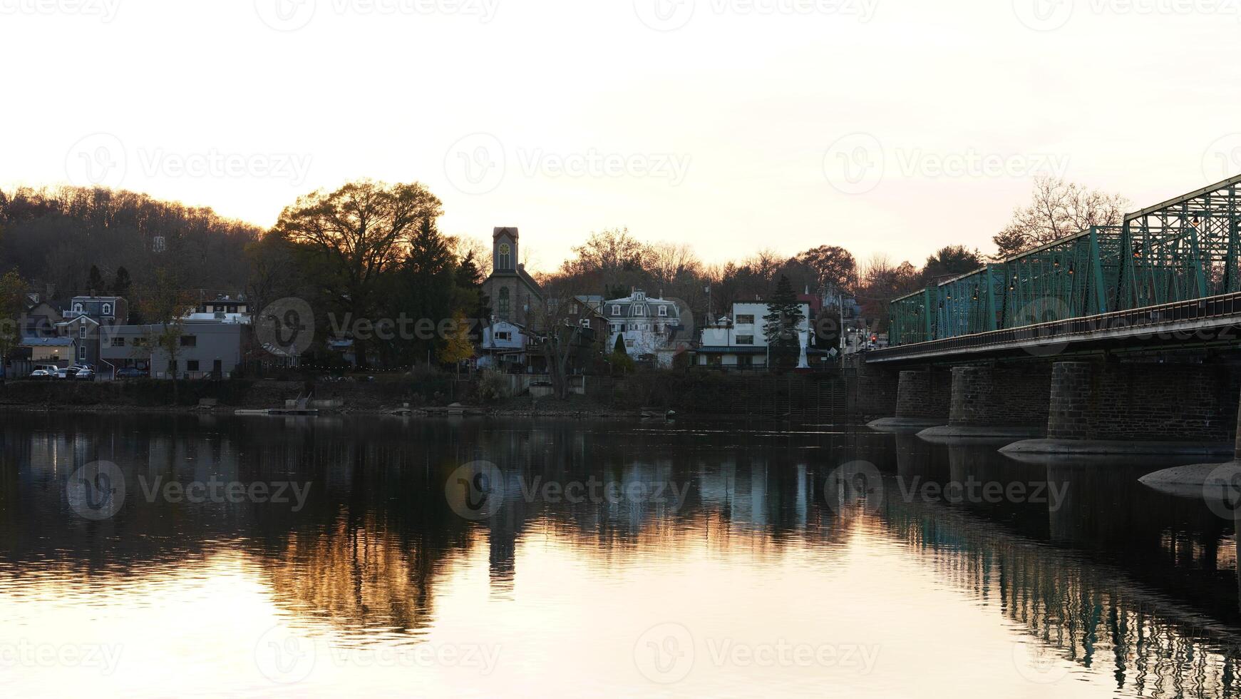 One old rion frames bridge view on the river with the sunset sky as background photo