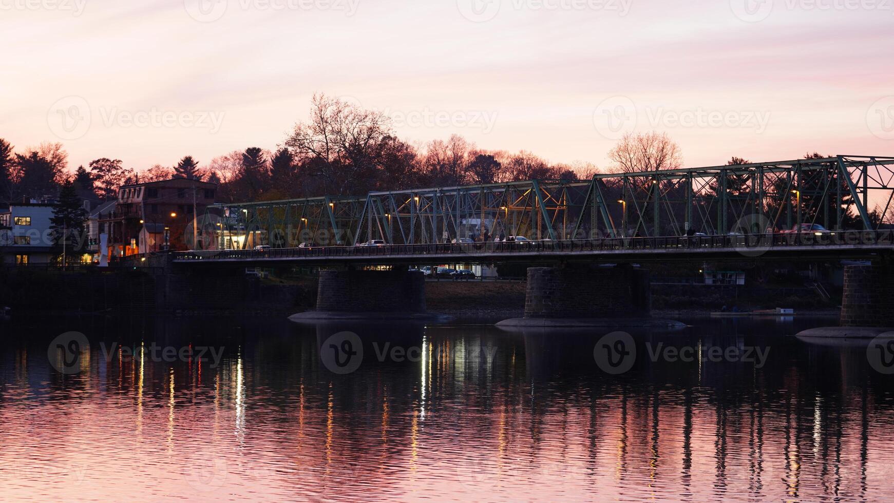 One old rion frames bridge view on the river with the sunset sky as background photo