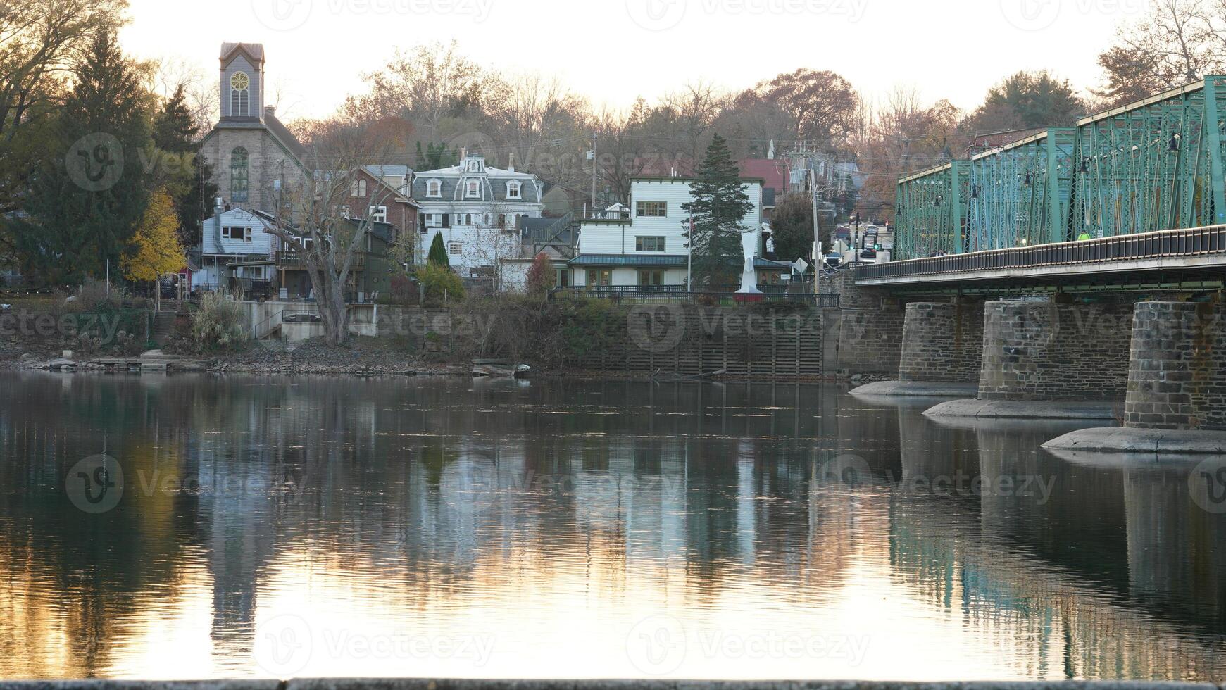 One old rion frames bridge view on the river with the sunset sky as background photo