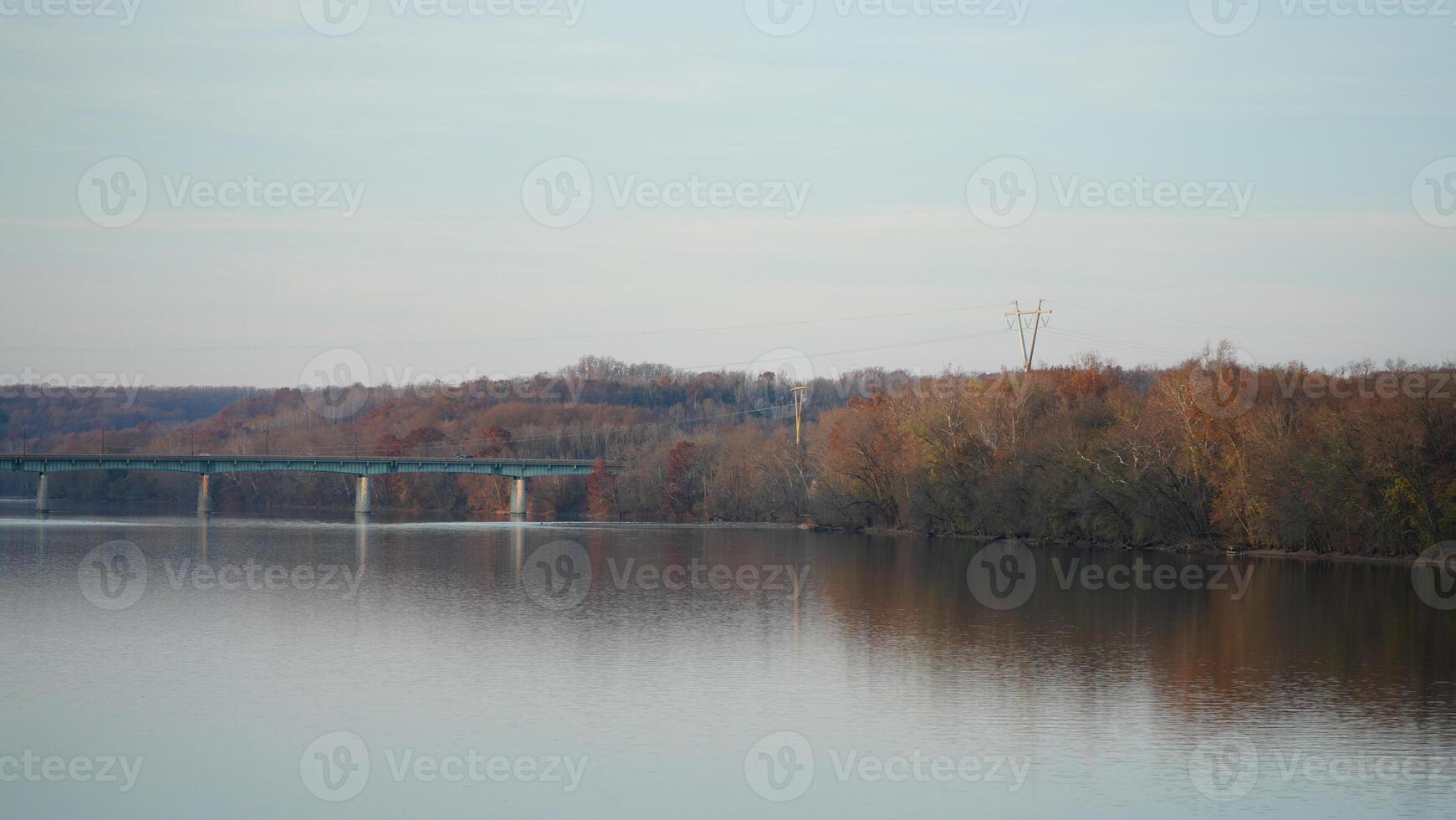 One old rion frames bridge view on the river with the sunset sky as background photo