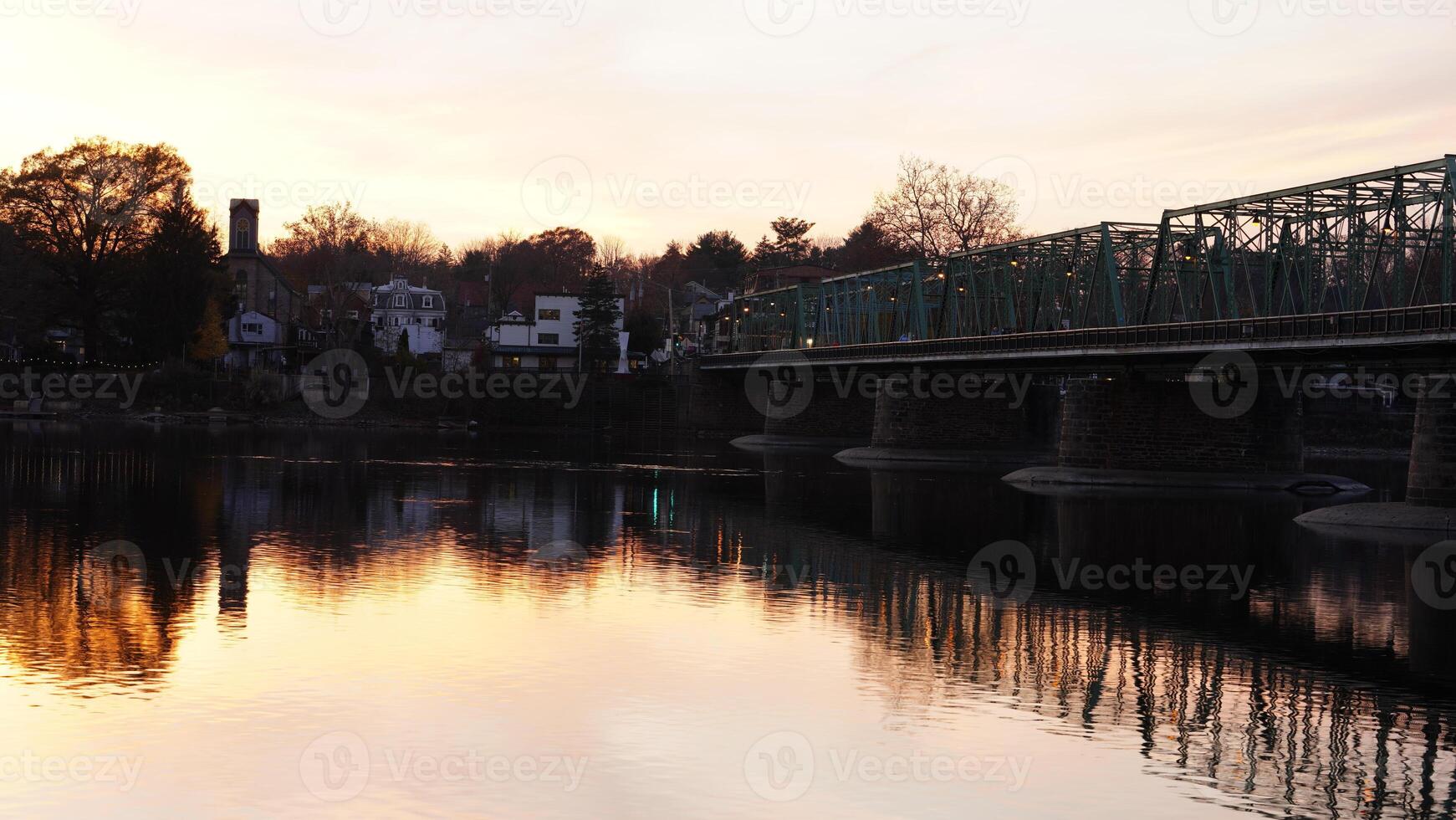 One old rion frames bridge view on the river with the sunset sky as background photo