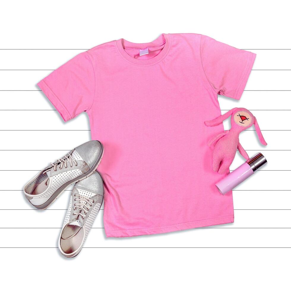 a pink t - shirt, sneakers and a pink purse photo