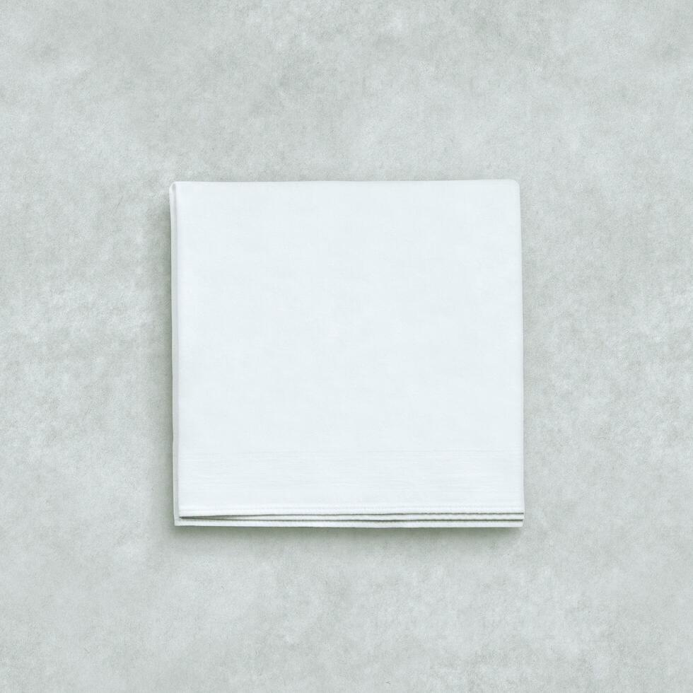 a folded white napkin on a gray background photo
