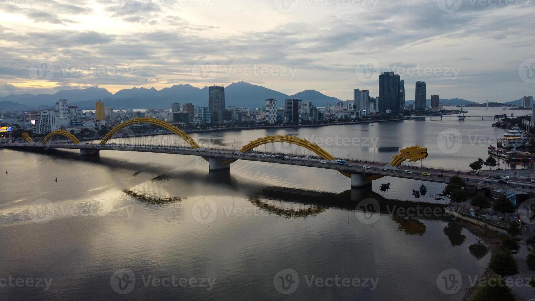 Dragon Bridge Cau Rong, traffic and skyline during sunset in Danang, Vietnam. photo