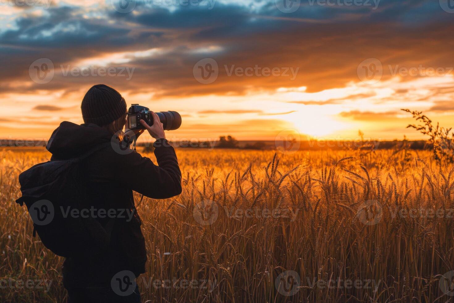 Photographer Capturing Golden Hour in a Field of Wheat photo