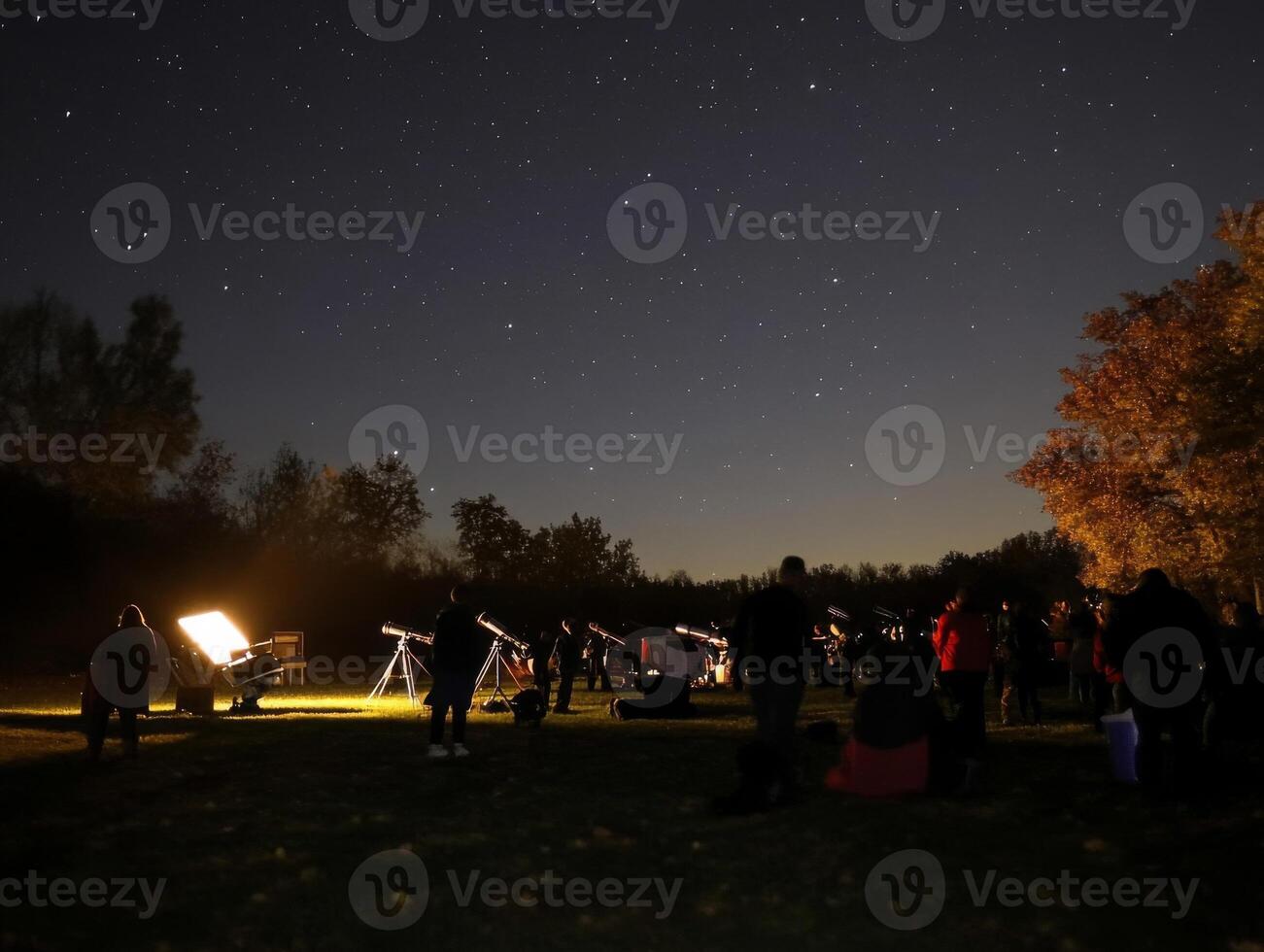 Stargazing Event with Telescopes Under a Night Sky photo