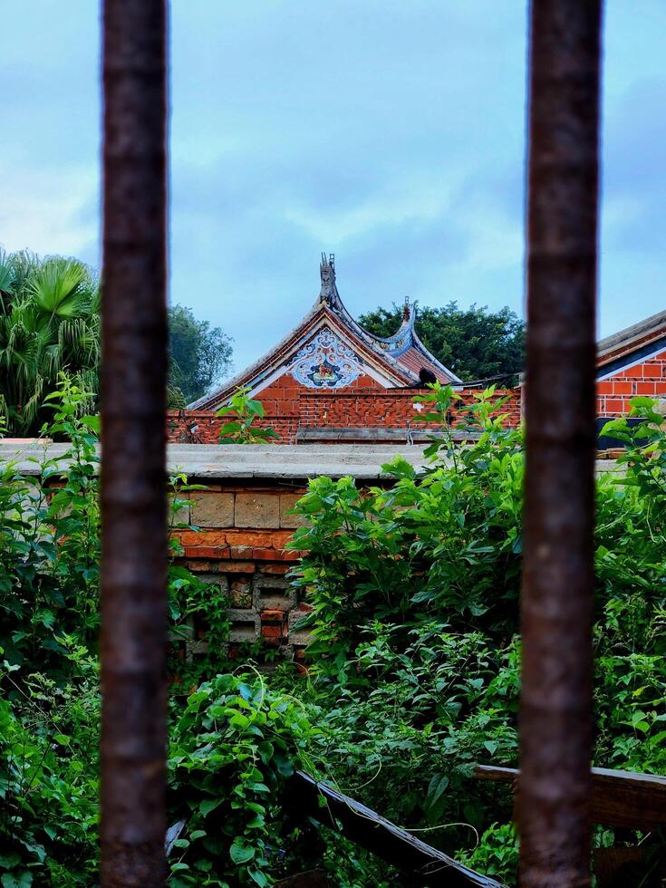 A view of a building through a fence photo