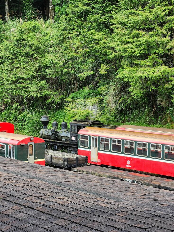 A red train on a wooden platform photo
