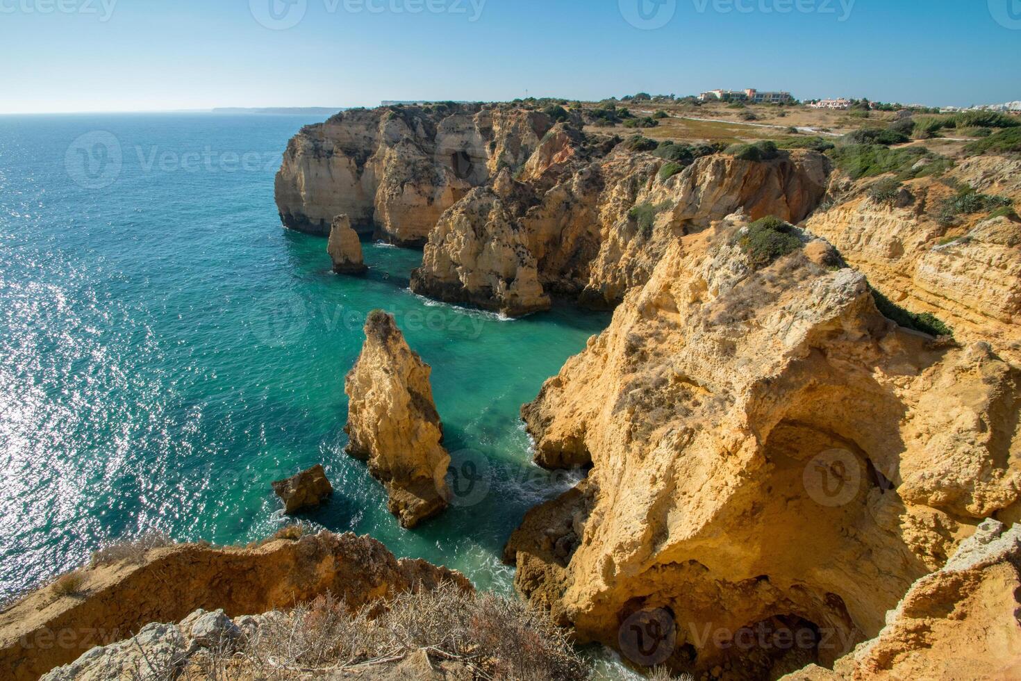 a view over some of the natural rocky bays found at Algarve in southern Portugal photo