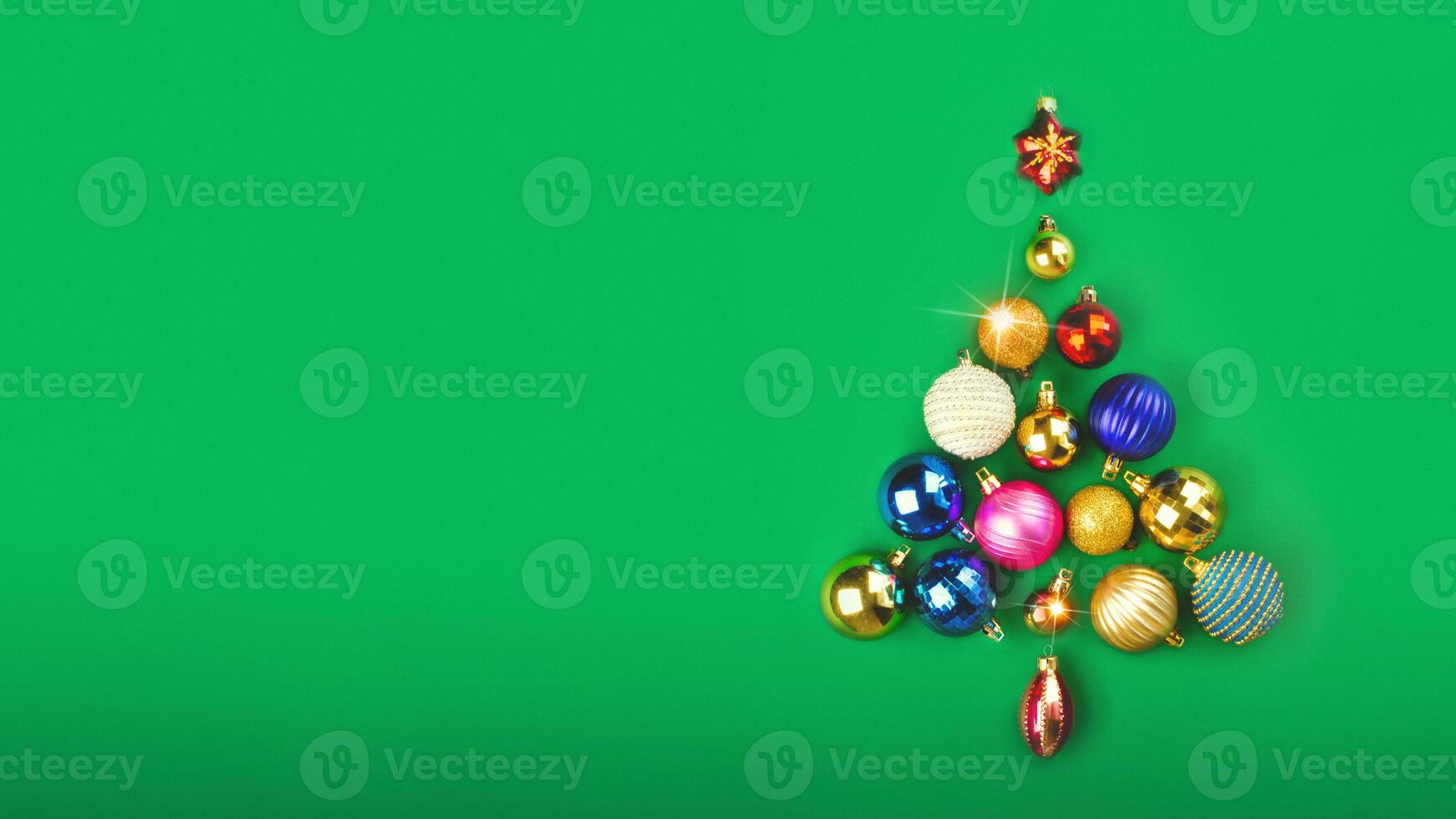 The Christmas tree is made of Christmas balls decoration. Minimum New Year concept. Card poster banner copy space green background photo