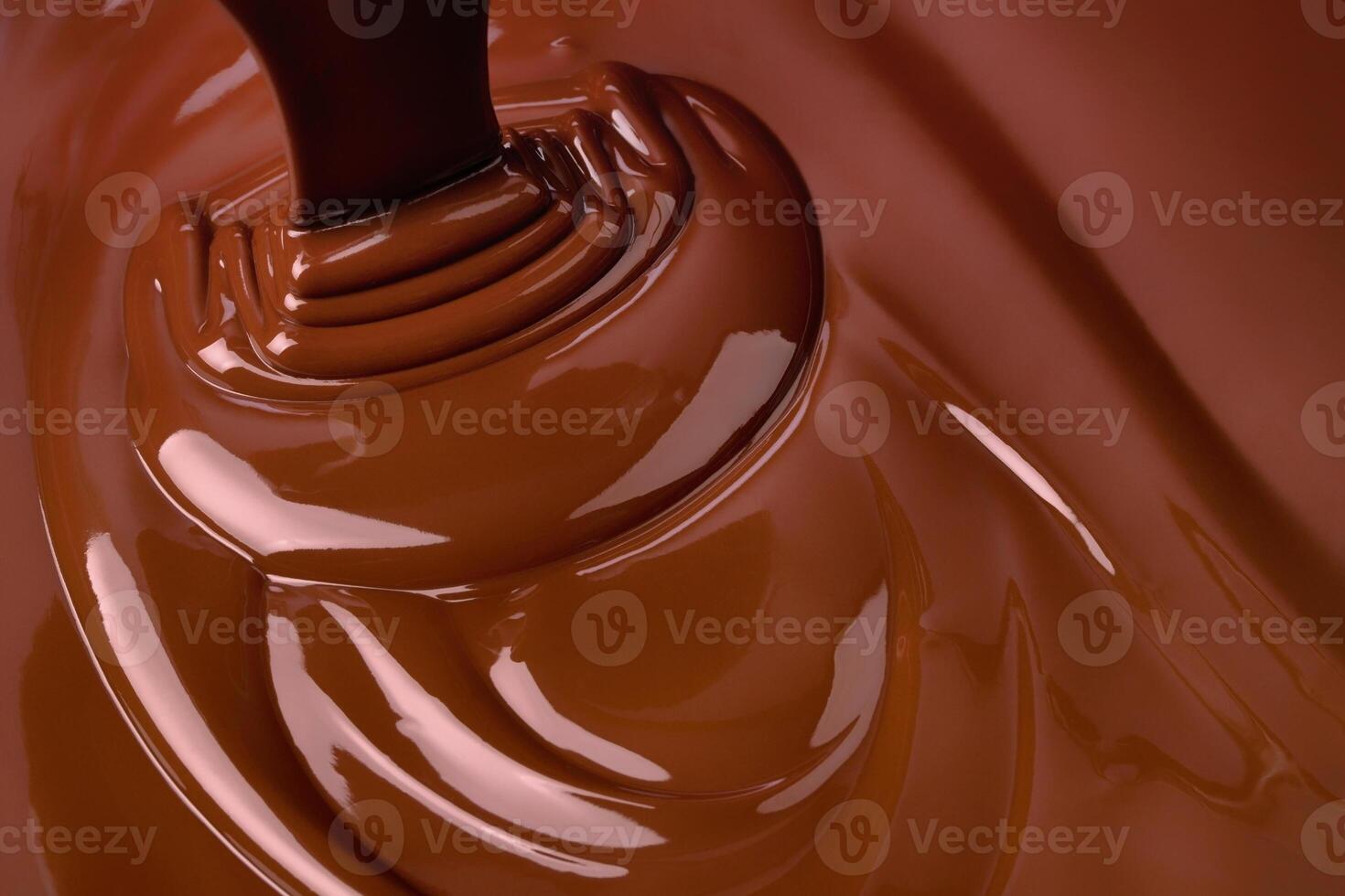 stream melt chocolate spreads in waves. hot cocoa background photo