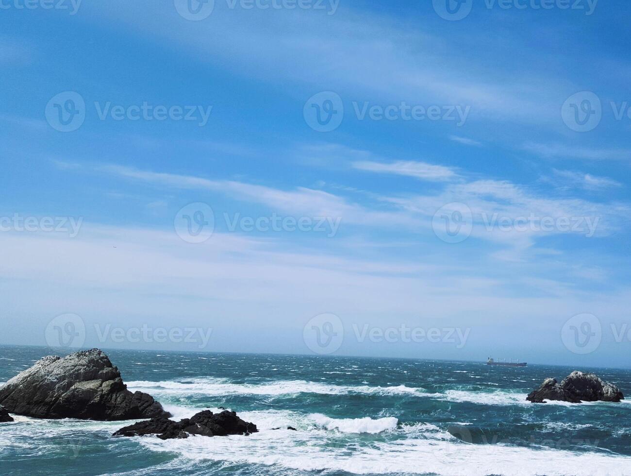 A view of the ocean from a rocky shore photo