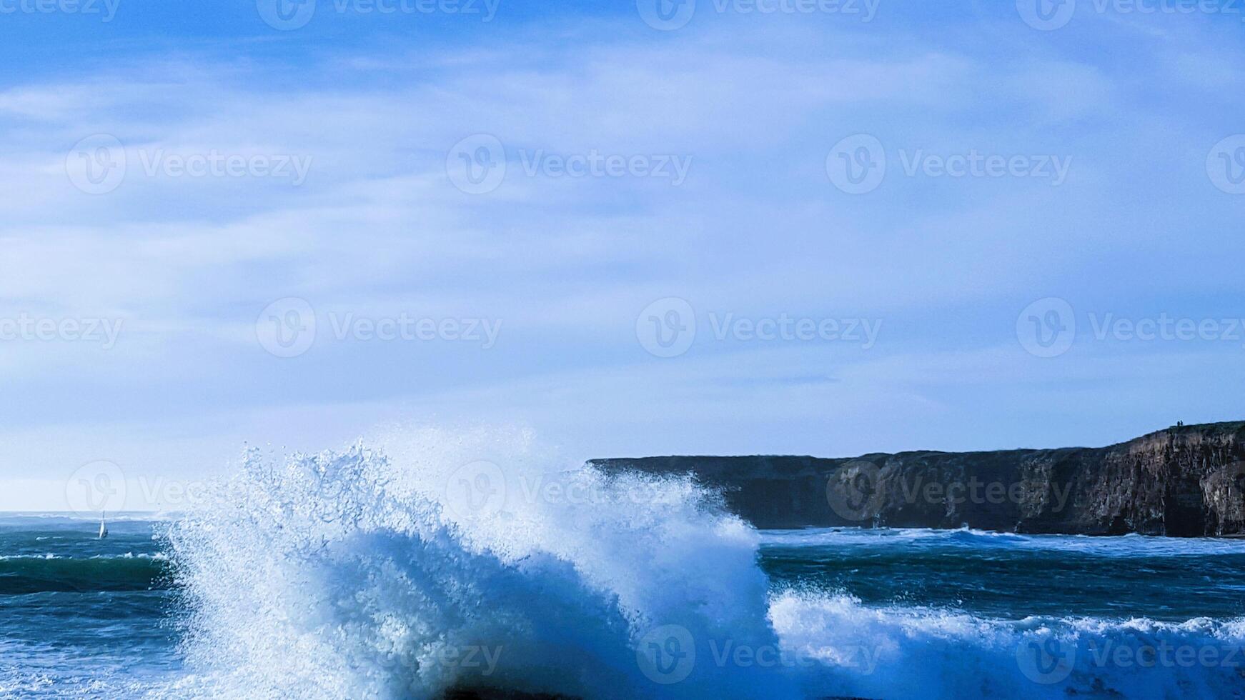 A large wave crashing into the ocean photo