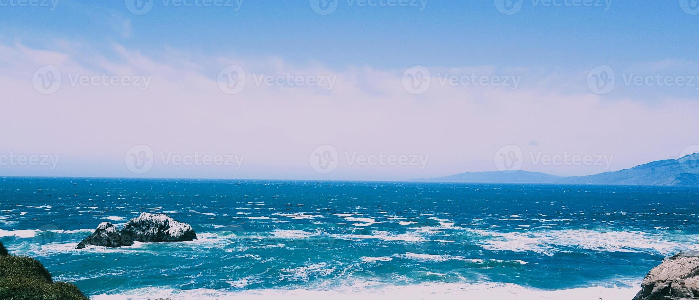 A view of the ocean from a cliff overlooking the ocean photo