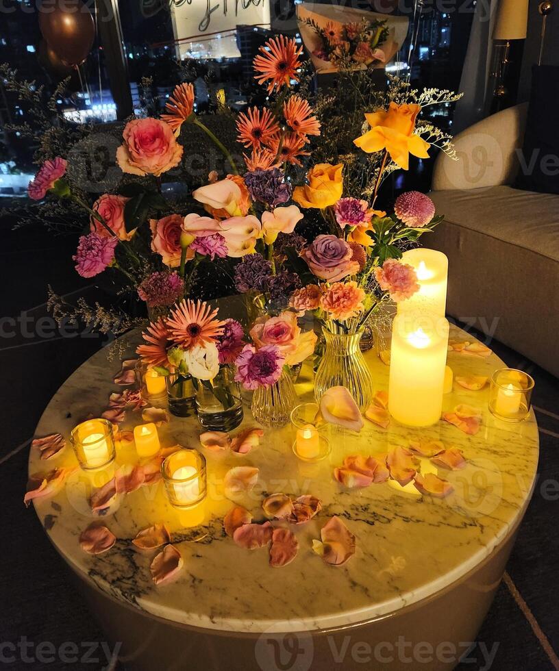 A table with candles and flowers on it photo
