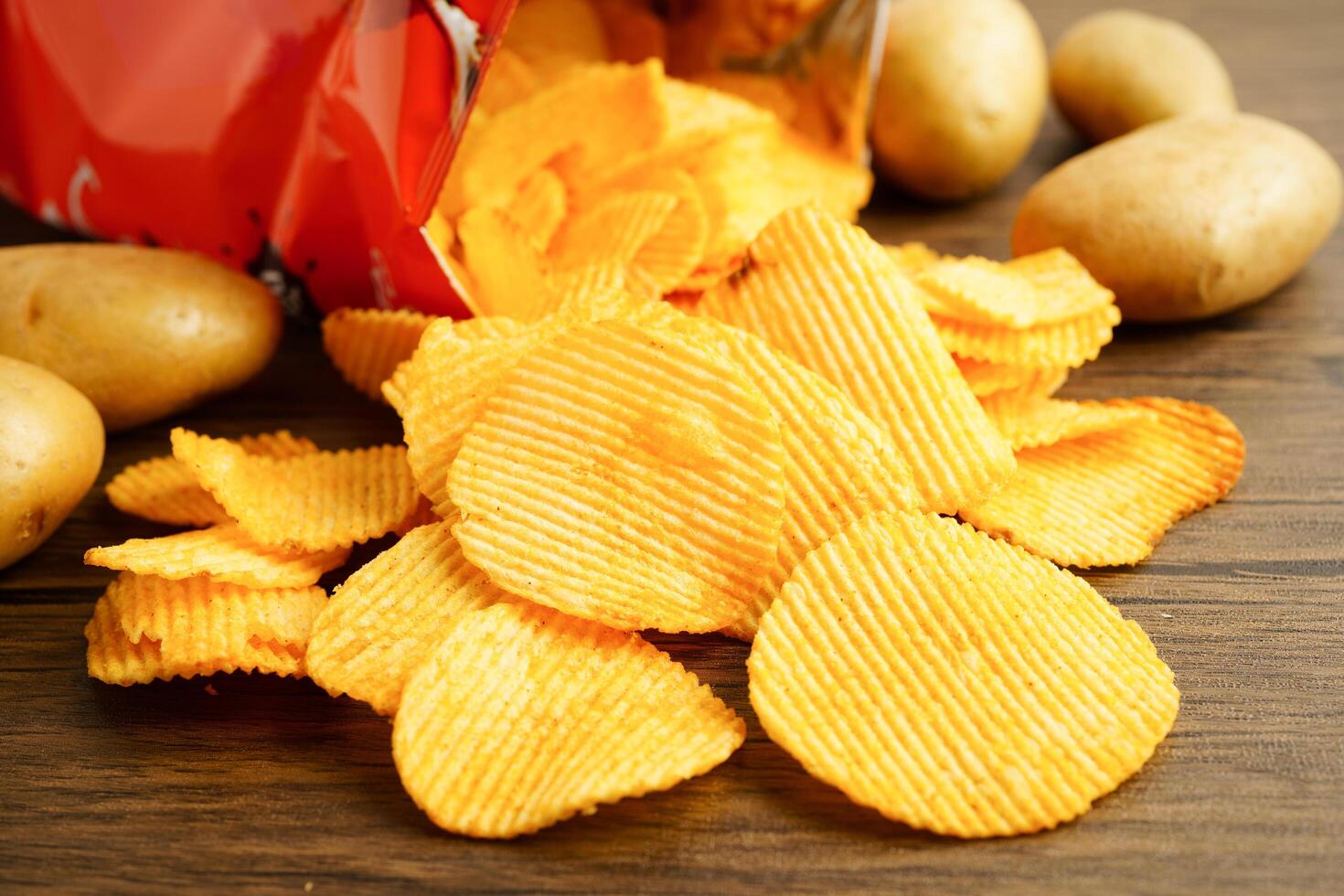 Potato chips , delicious BBQ seasoning spicy for crips, thin slice deep fried snack fast food. photo
