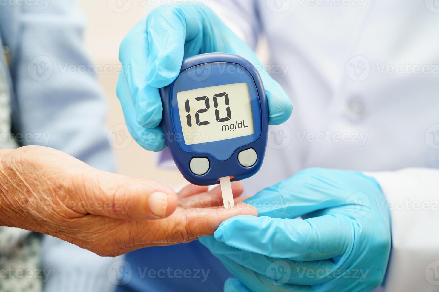 Doctor use digital glucose monitor measure and test stripe for check diabetes from finger blood sugar level. photo