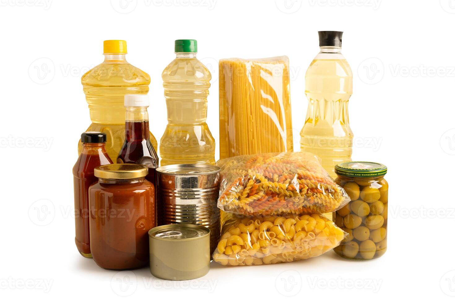 Foodstuff for donation isolated on white background with clipping path, storage and delivery. Various food, pasta, cooking oil and canned food. photo