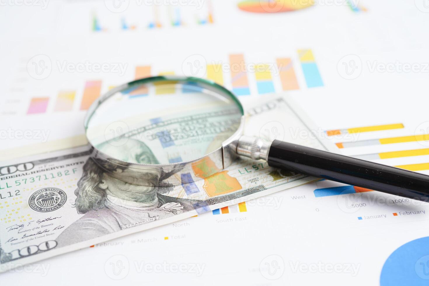 Magnifying glass on charts graphs paper. Financial development, Banking Account, Statistics, Investment Analytic research data economy. photo