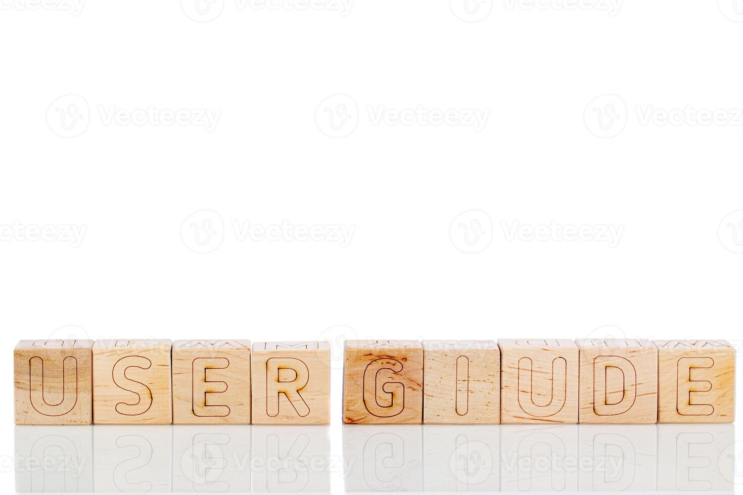 Wooden cubes with letters user giude on a white background photo