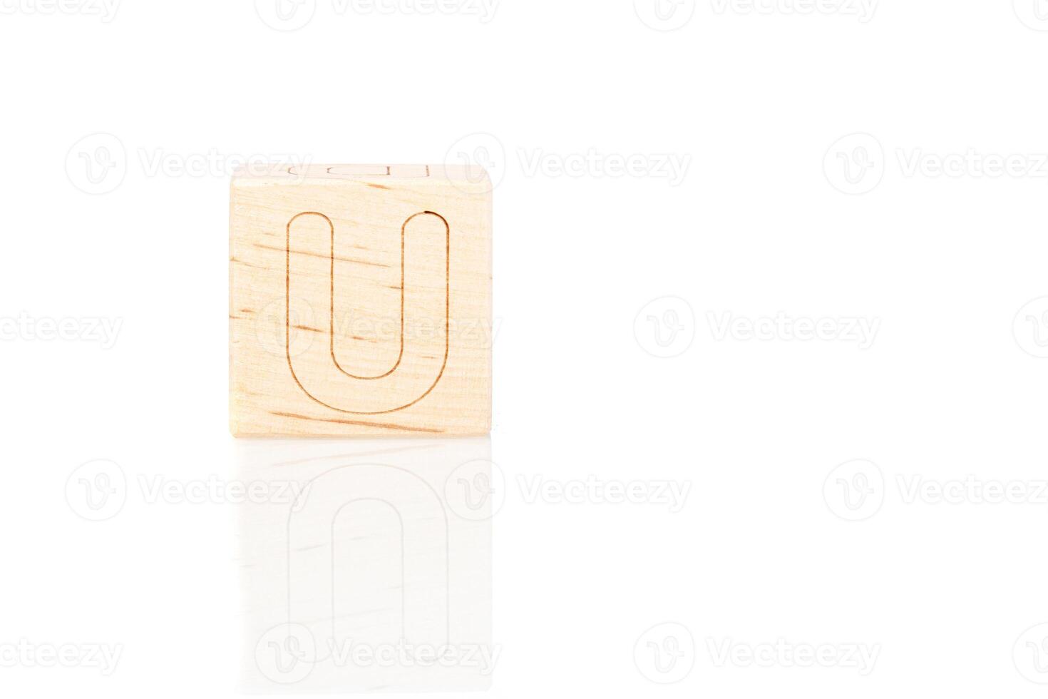 Wooden cubes with letters U on a white background photo