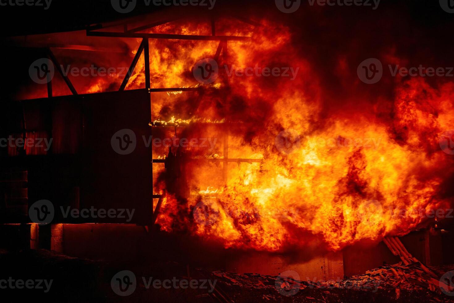 Exploding warehouse. Burning industrial building. Big blaze at night photo