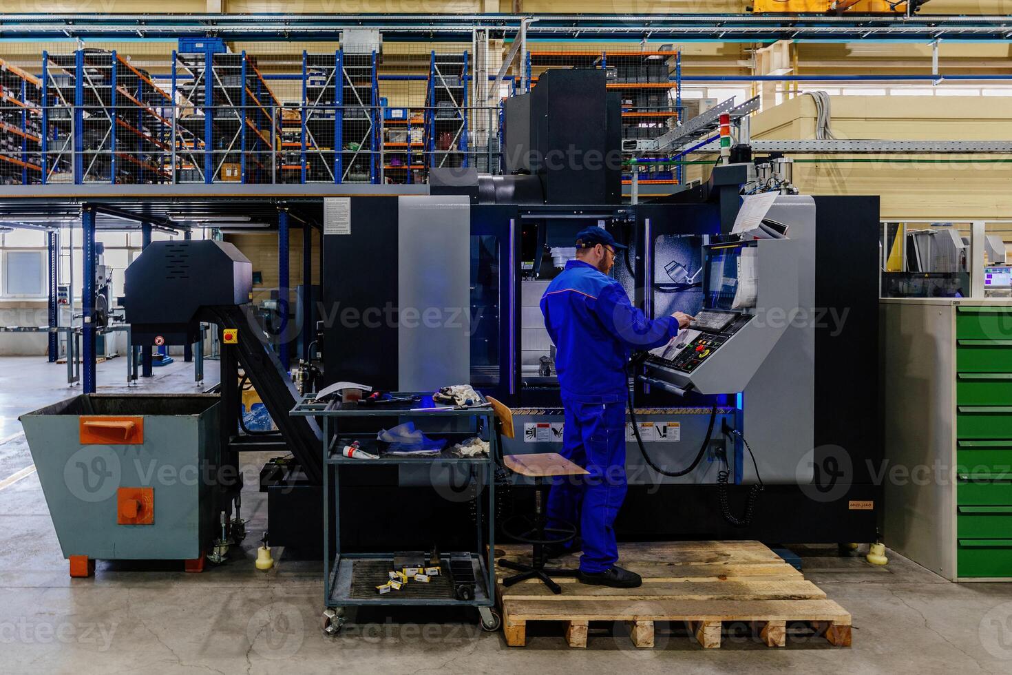 Operator works with modern CNC milling and cutting machinery photo