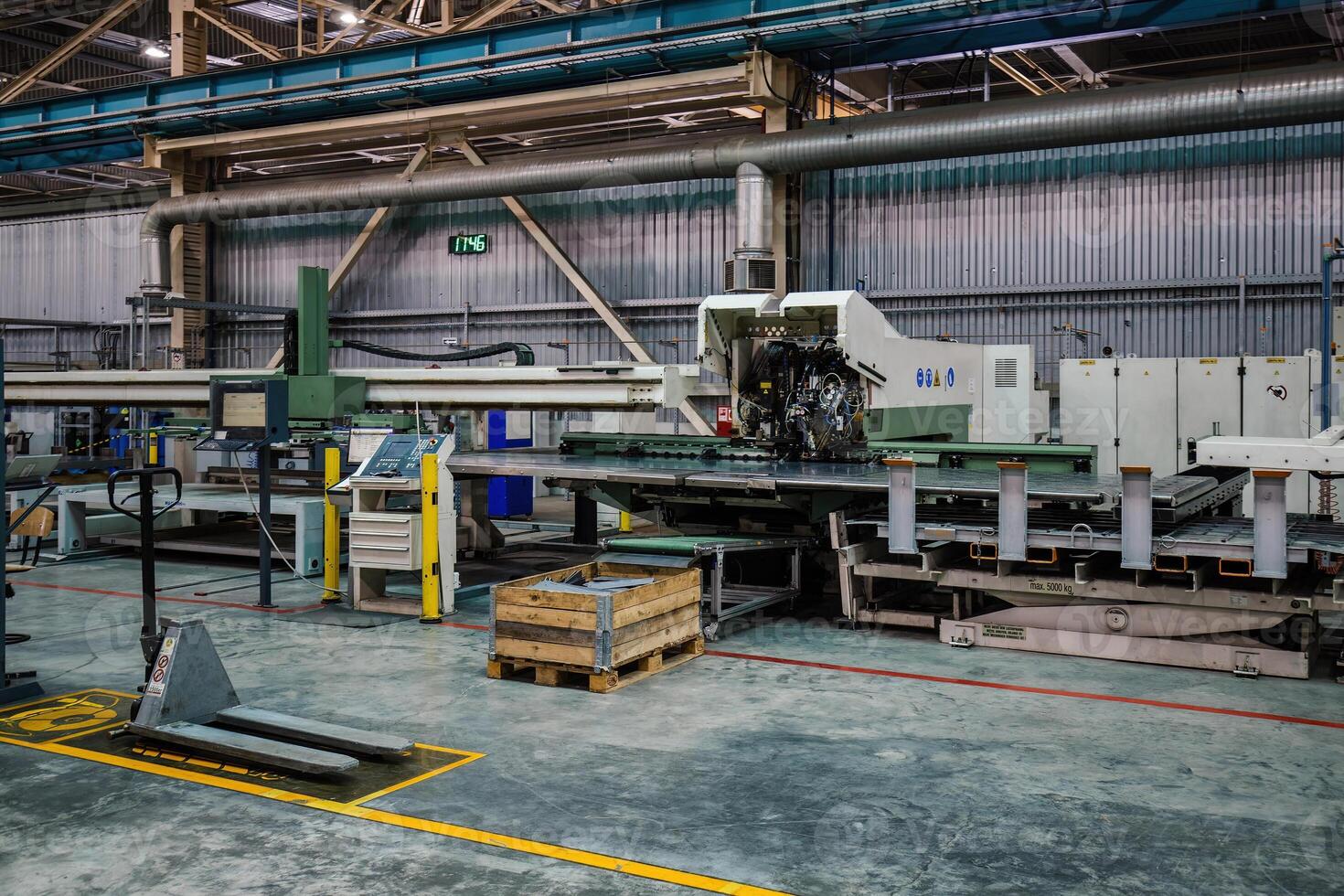 Modern CNC perforation machine in metalworking factory photo